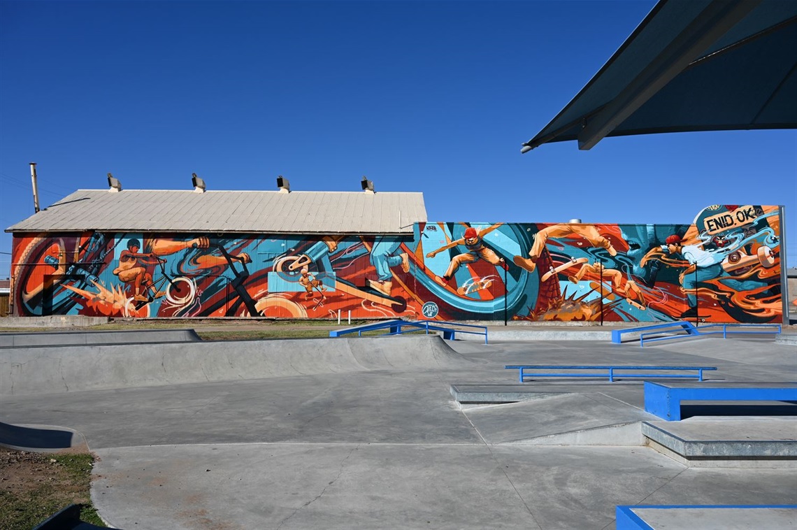 Photo of a mural at the skate park that contains characters performing skate tricks