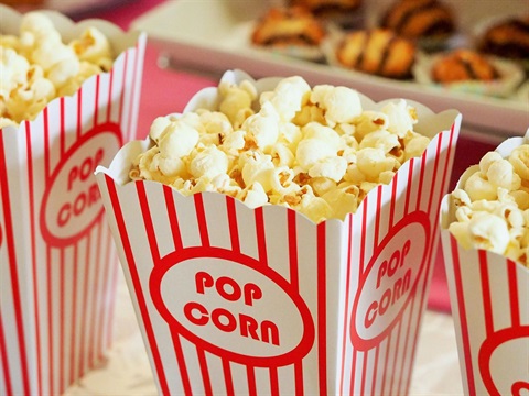 Photo of striped popcorn buckets filled with popcorn